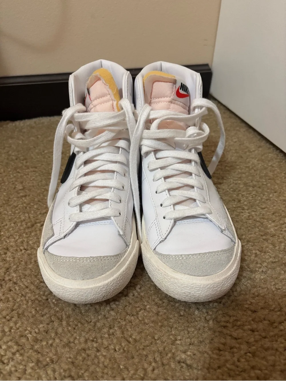 Nike White High-Top Sneakers with Black Swoosh and Yellow Tongue